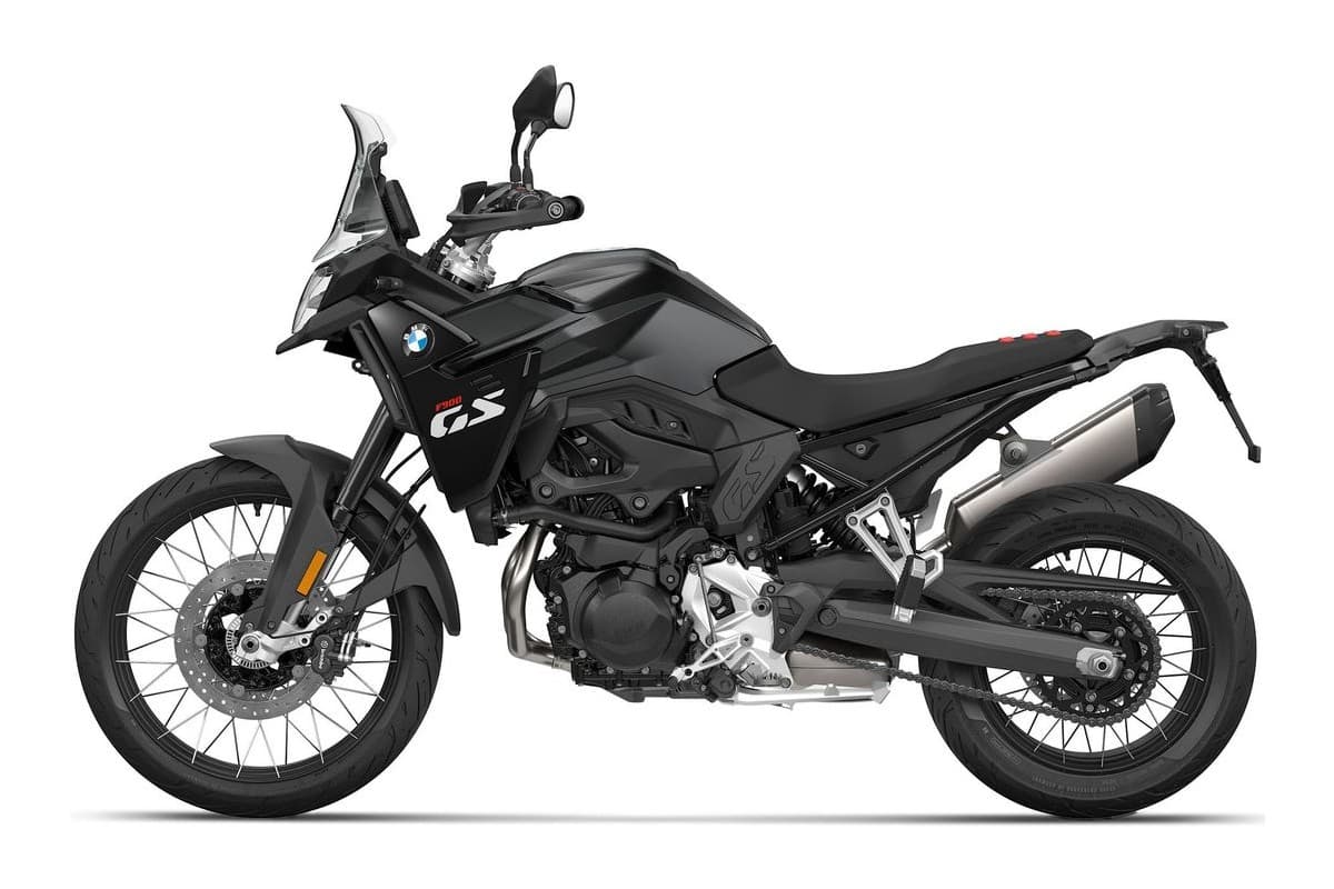 2027 BMW F 900 GS adventure motorcycle in blue and black, right-side studio profile showing spoked wheels, Akrapovic-style exhaust and tall windscreen