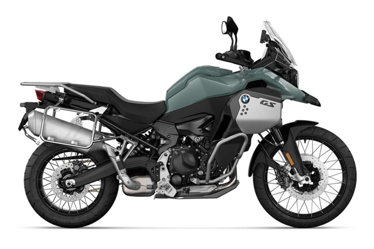 2027 BMW F 900 GS Adventure in sage green and silver, right-side studio profile with spoked wheels, aluminum panniers and tall windscreen