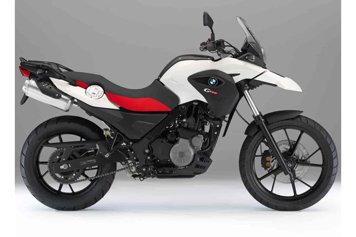 2016 BMW G650GS in white with red and black accents, right-side studio profile showing the single-cylinder engine, spoked wheels and stubby exhaust