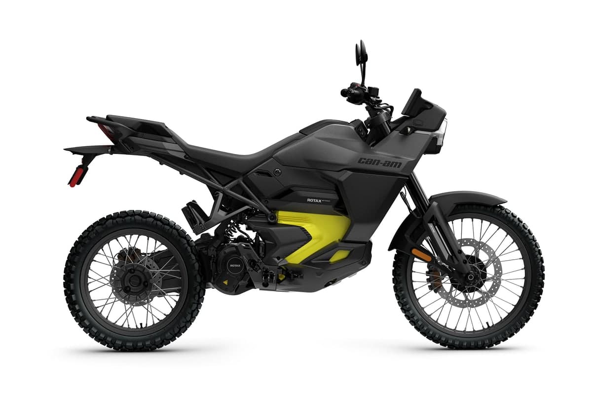 2026 Can-Am Origin electric dual sport in carbon black with yellow accents, left-side studio profile on a white background
