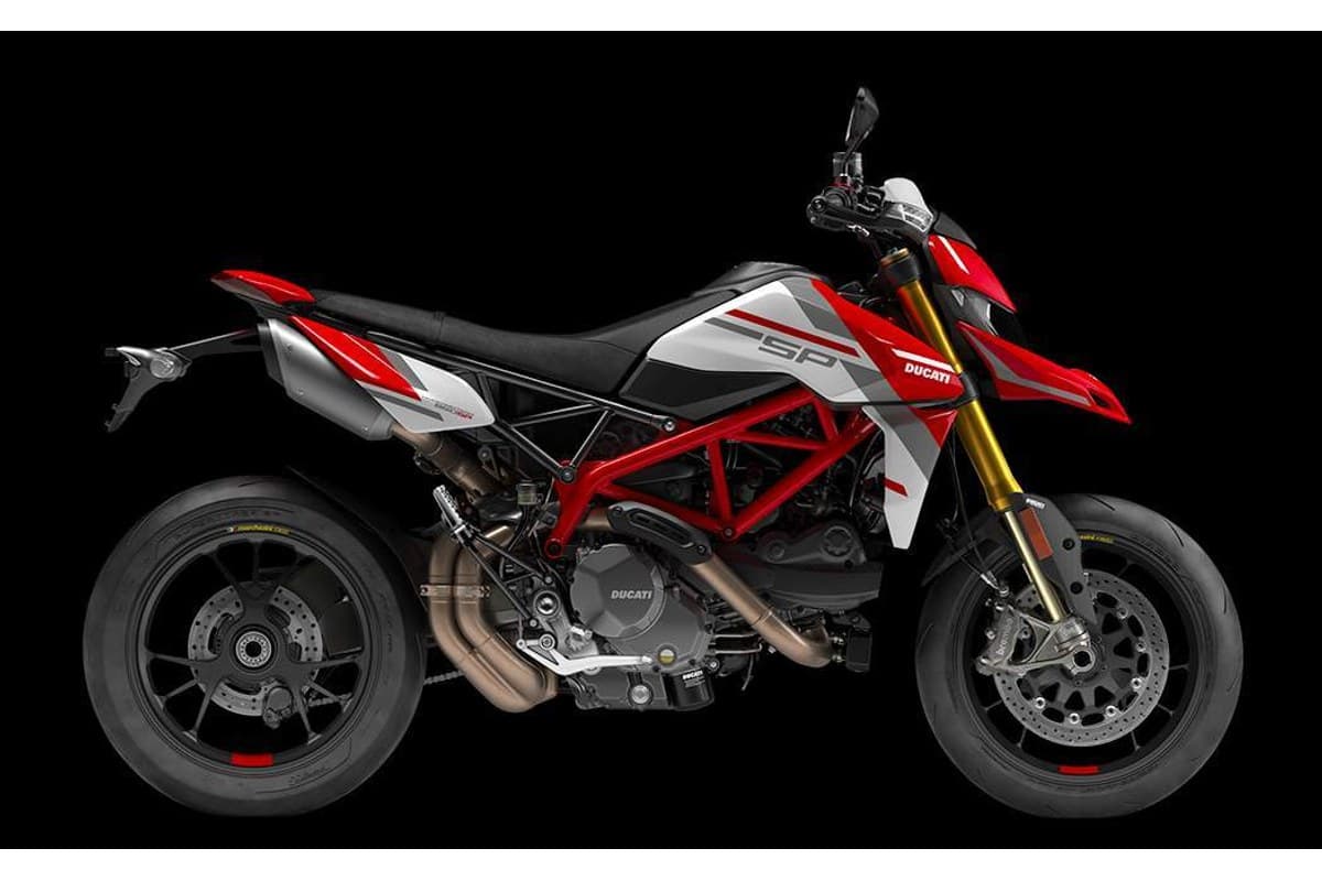 2025 Ducati Hypermotard 950 SP in red and white livery, right-side studio profile showing the trellis frame, gold Marzocchi forks and Ducati Corse graphics