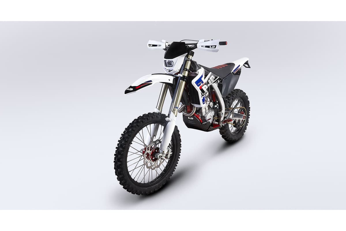 AJP SPR510R front three-quarter studio view showing the enduro headlight cowl, Sachs 48mm fork and Brembo front disc