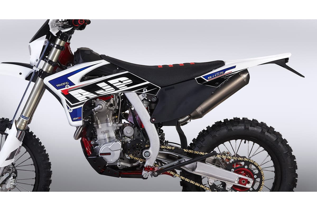 Close-up of the AJP SPR510R's left side, showing the 501cc DOHC engine, red chassis spars and header pipe