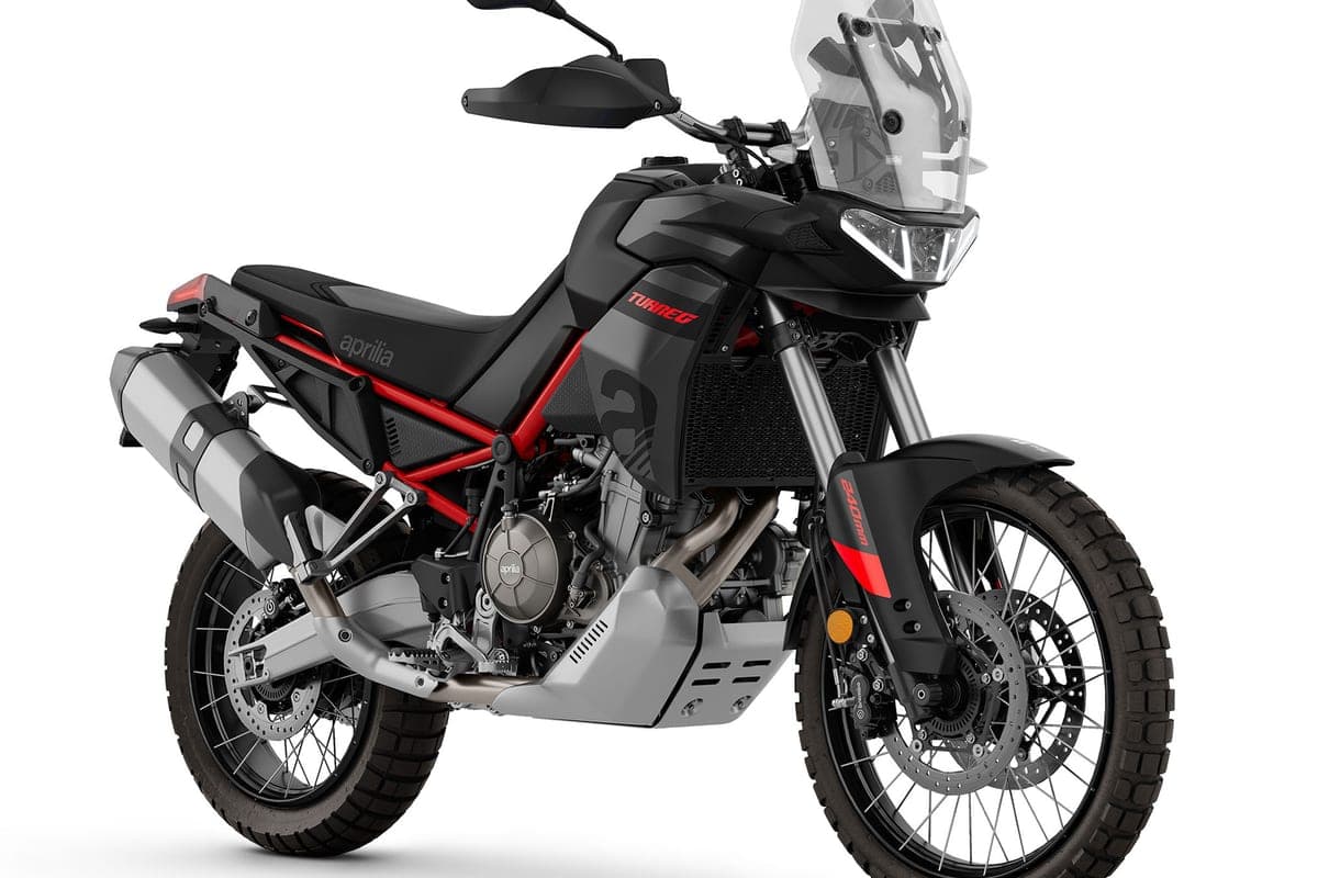 Aprilia Tuareg 660 front three-quarter studio view in black with red graphics, showing the LED headlight, radiator shroud and long-travel forks