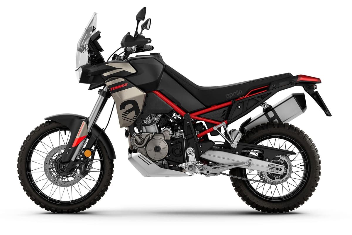 Aprilia Tuareg 660 in a black and champagne color scheme, left-side studio profile highlighting the twin-spar frame and underslung exhaust