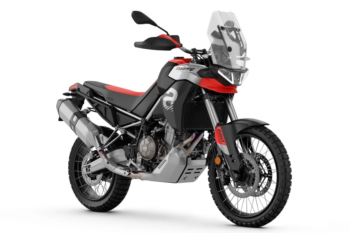 Aprilia Tuareg 660 front three-quarter studio shot in white, red and black livery, showing the beak fender, cast headlight unit and knobby front tire