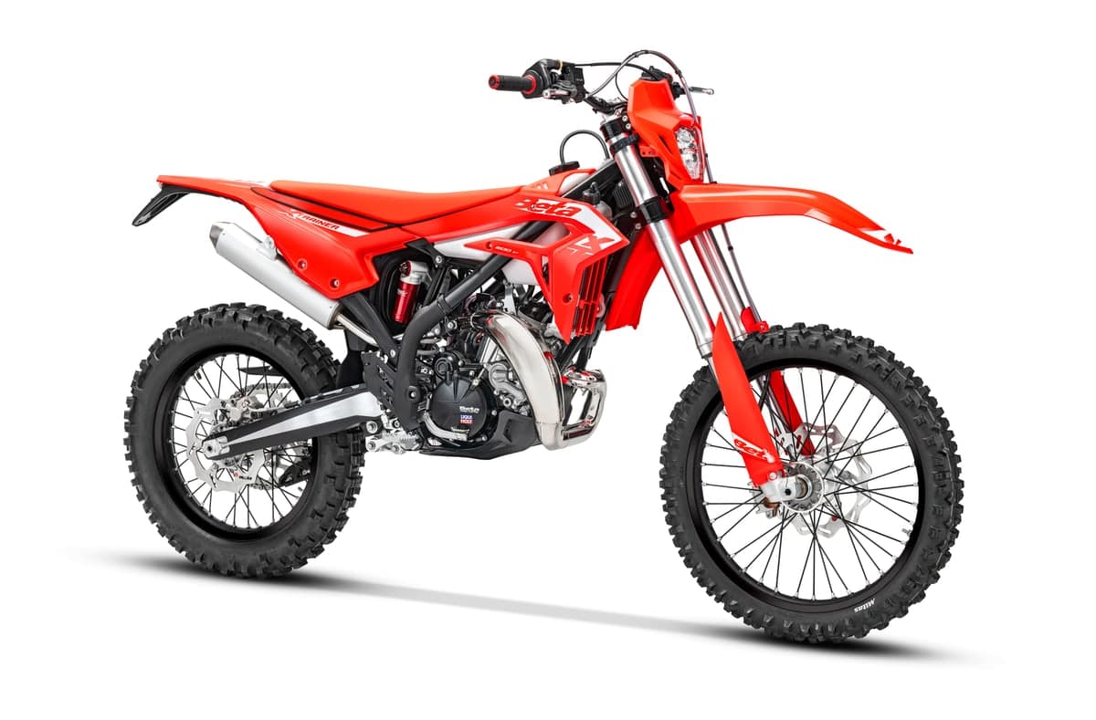 Beta Xtrainer 200 in red and white, front three-quarter studio view highlighting the inverted forks, headlight and slim radiator shrouds