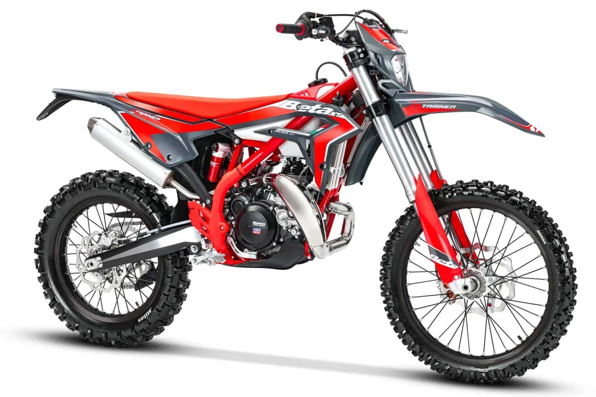 Beta Xtrainer 300 front three-quarter studio view in red and gray livery, showing the headlight, inverted forks and red frame