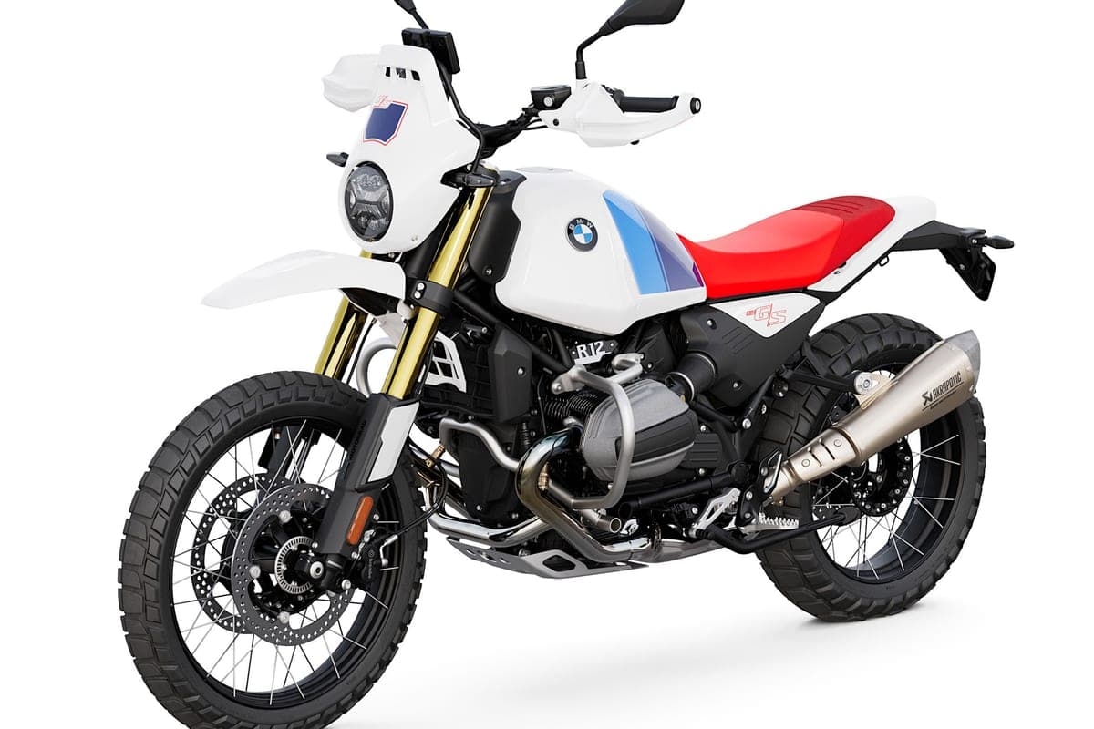 BMW R 12 G/S front three-quarter studio view highlighting the gold-finish forks, round LED headlight, white beak fender and Akrapovic exhaust can