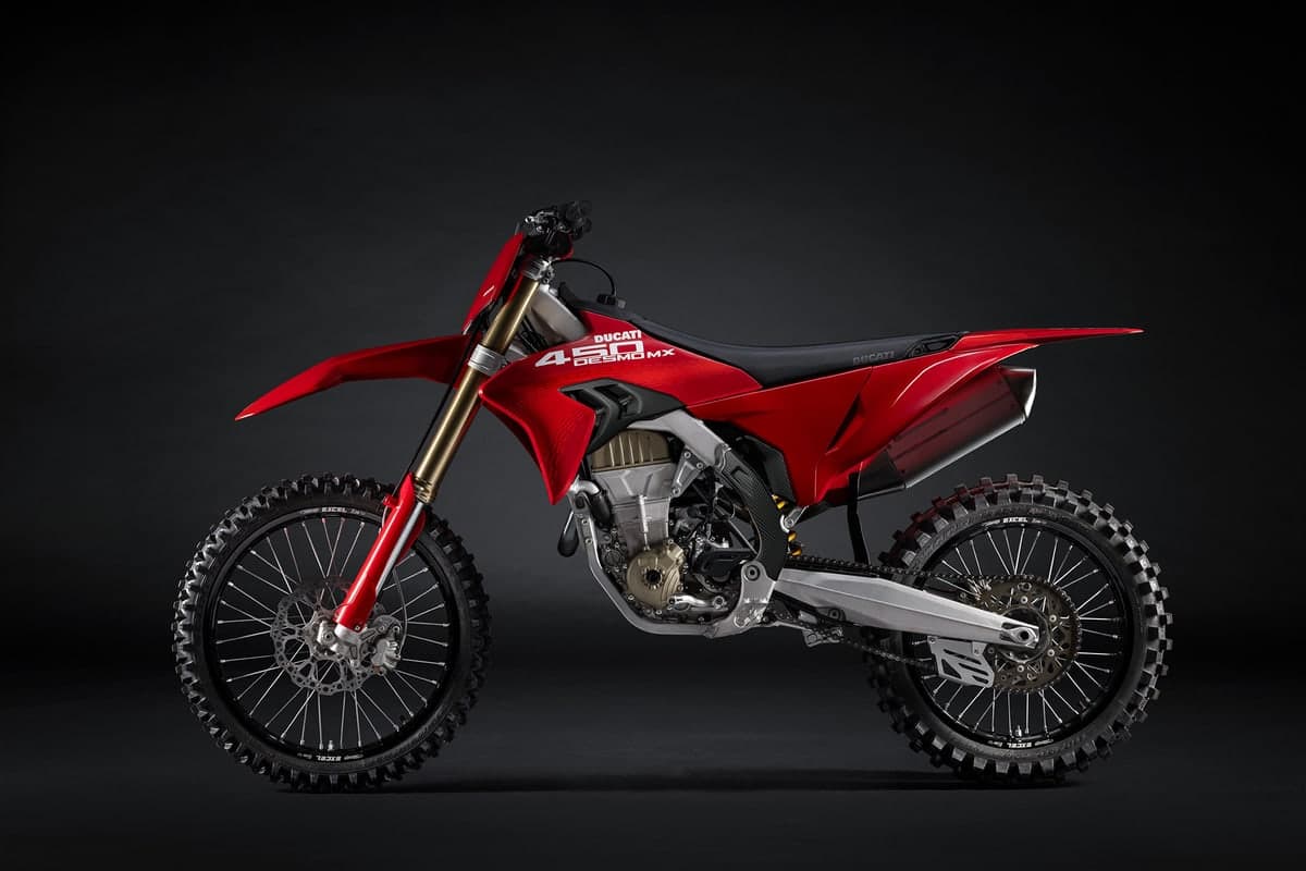 Ducati Desmo450 MX rear three-quarter studio shot highlighting the black seat, exhaust canister and machined swingarm