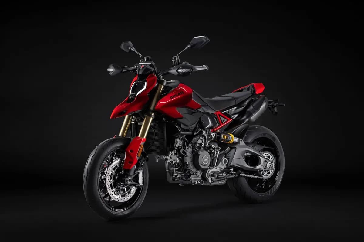 Ducati Hypermotard V2 in red, front three-quarter studio view highlighting the LED headlight, upside-down forks and V2 engine cases