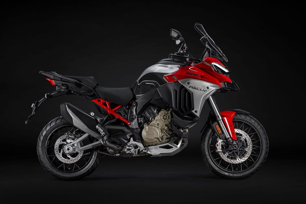 Multistrada V4 Rally left-side studio profile on black background with red bodywork, RALLY graphics and desmodromic V4 engine visible below the tank