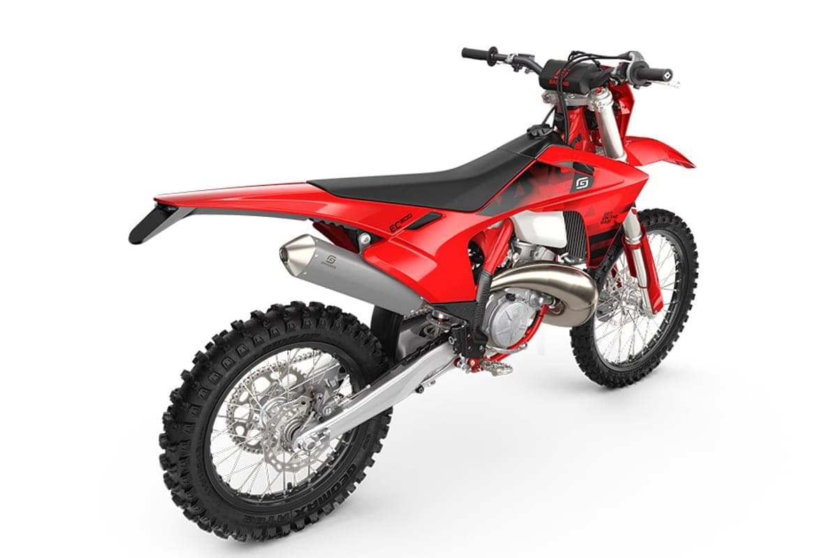 GasGas EC 300 rear three-quarter studio view highlighting the tucked exhaust pipe, WP fork guards and knobby Dunlop Geomax rear tire