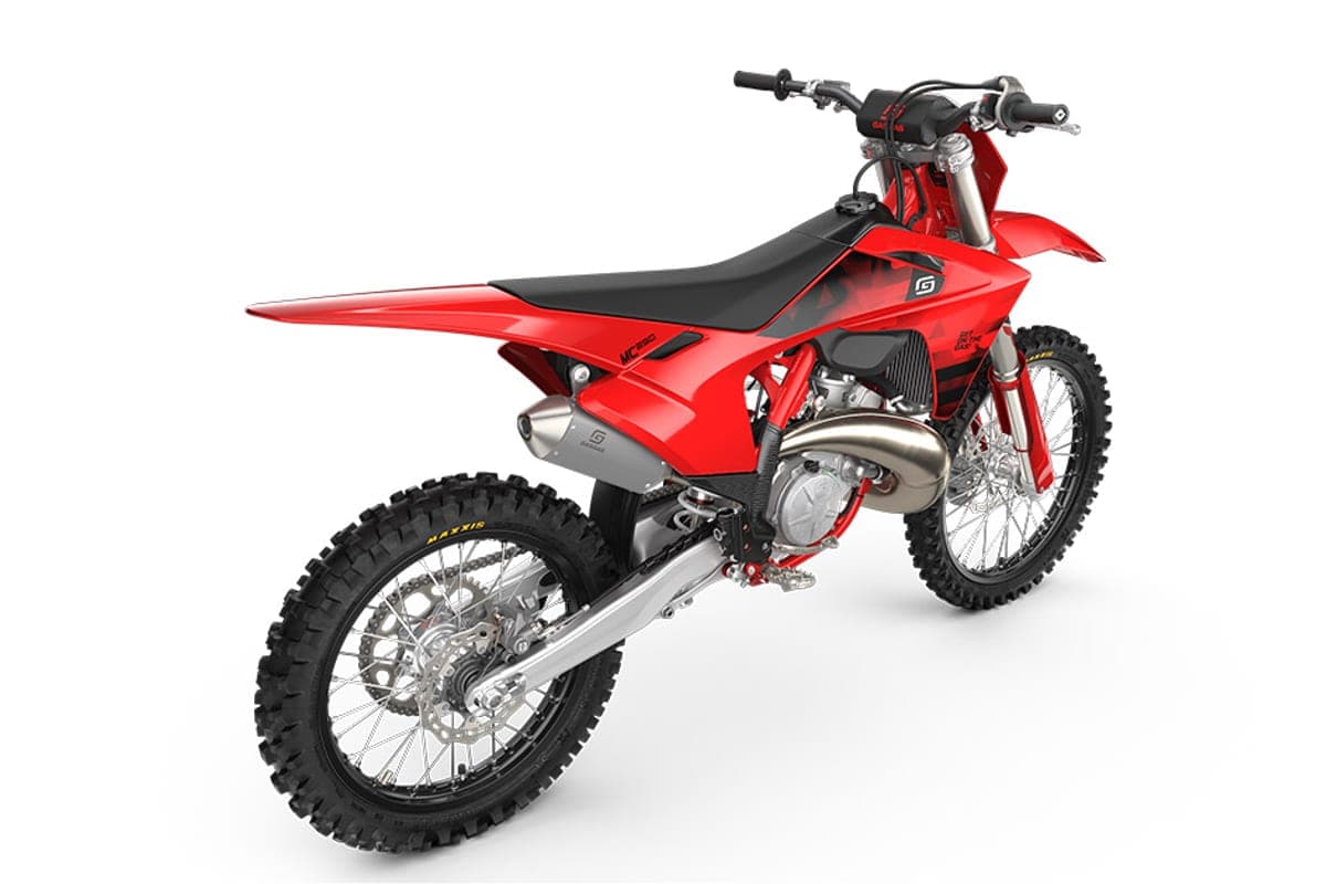 GasGas MC 250 rear three-quarter studio view highlighting the chrome exhaust pipe, spoked wheels and Maxxis knobby tires
