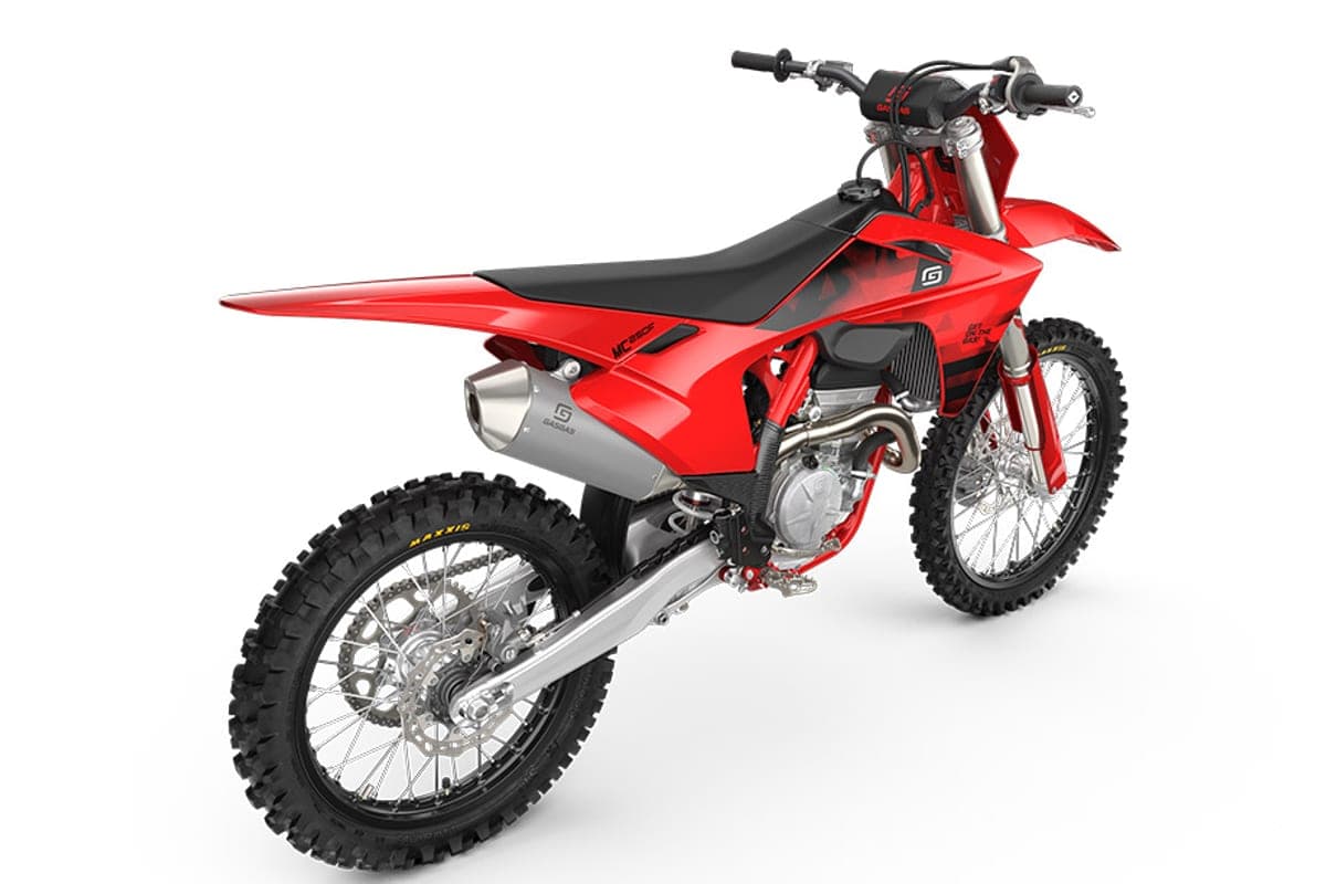 GasGas MC 250F rear three-quarter studio shot showing the number plate, seat, silver exhaust tip and spoked rear wheel