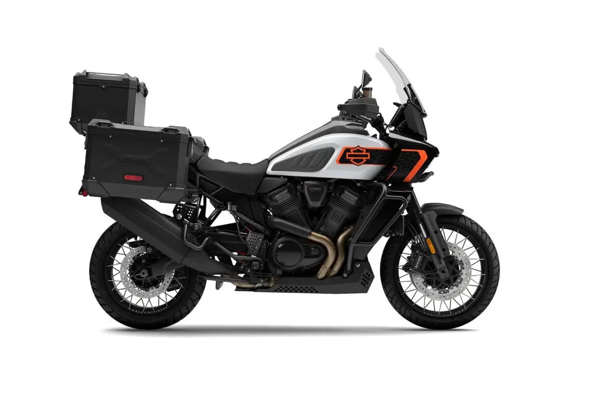 Harley-Davidson Pan America 1250 Limited in silver with orange graphics, left-side studio profile showing spoked wheels and aluminum side cases