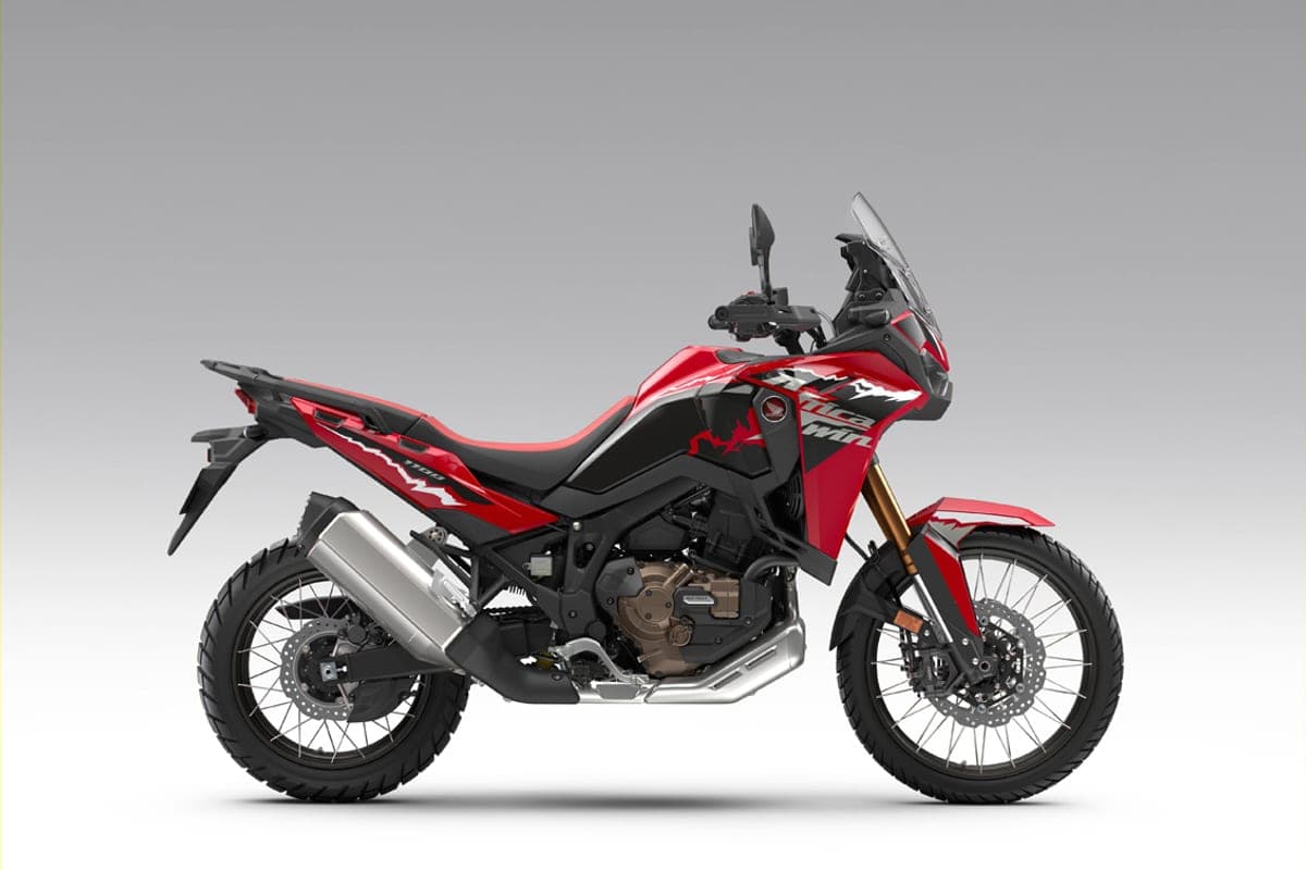 Honda Africa Twin CRF1100L in red and black livery, right-side studio profile highlighting the twin exhaust cans and gold upside-down fork