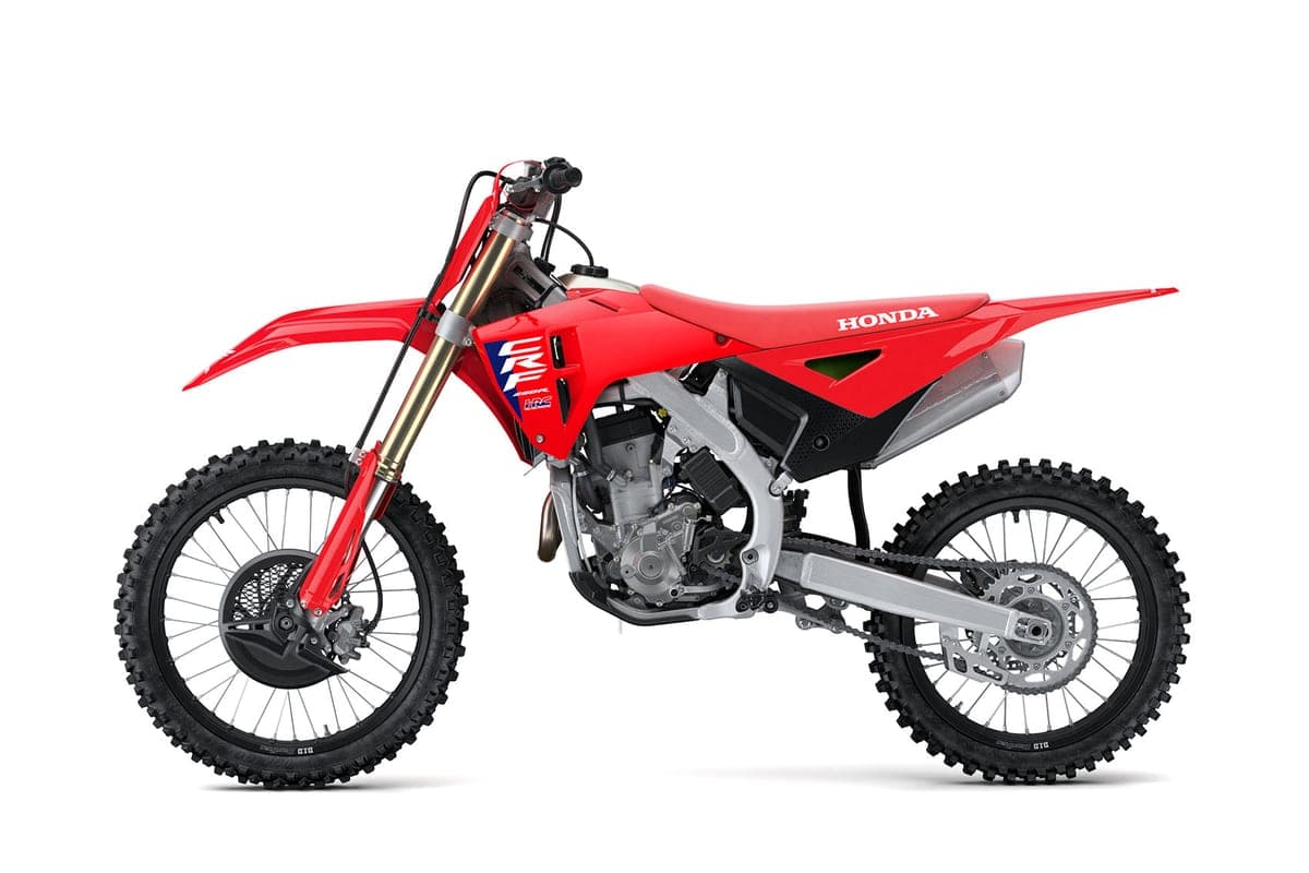 Honda CRF250R in red with white seat graphics, left-side studio profile showing the twin-spar frame and radiator shrouds