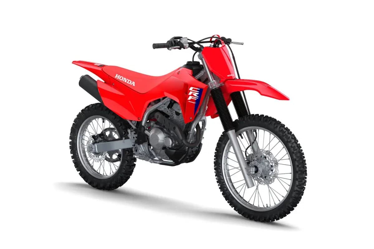 Honda CRF300F front three-quarter studio shot showing the front disc brake, headlight area and blue-and-white CRF side panel