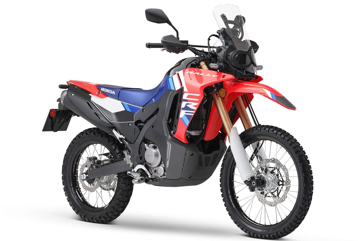 2026 Honda CRF300L Rally front three-quarter studio view highlighting the rally-style fairing, gold inverted forks and dual-sport tread