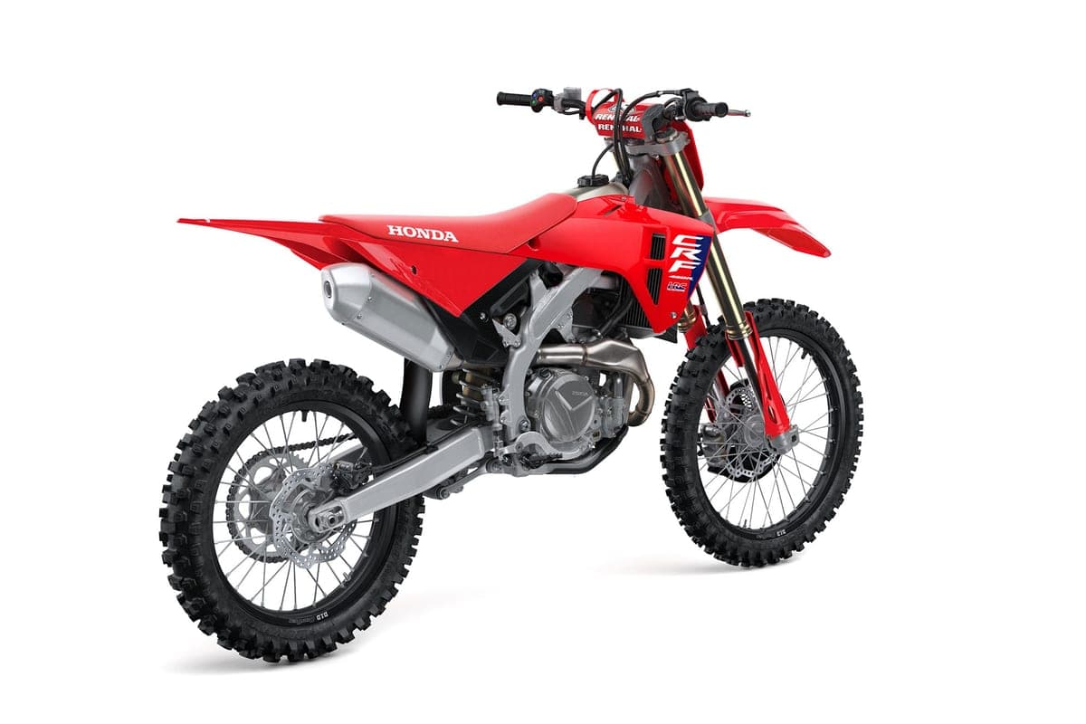 Honda CRF450R rear three-quarter studio view highlighting the CRF graphics panel, radiator shrouds, silver muffler and swingarm