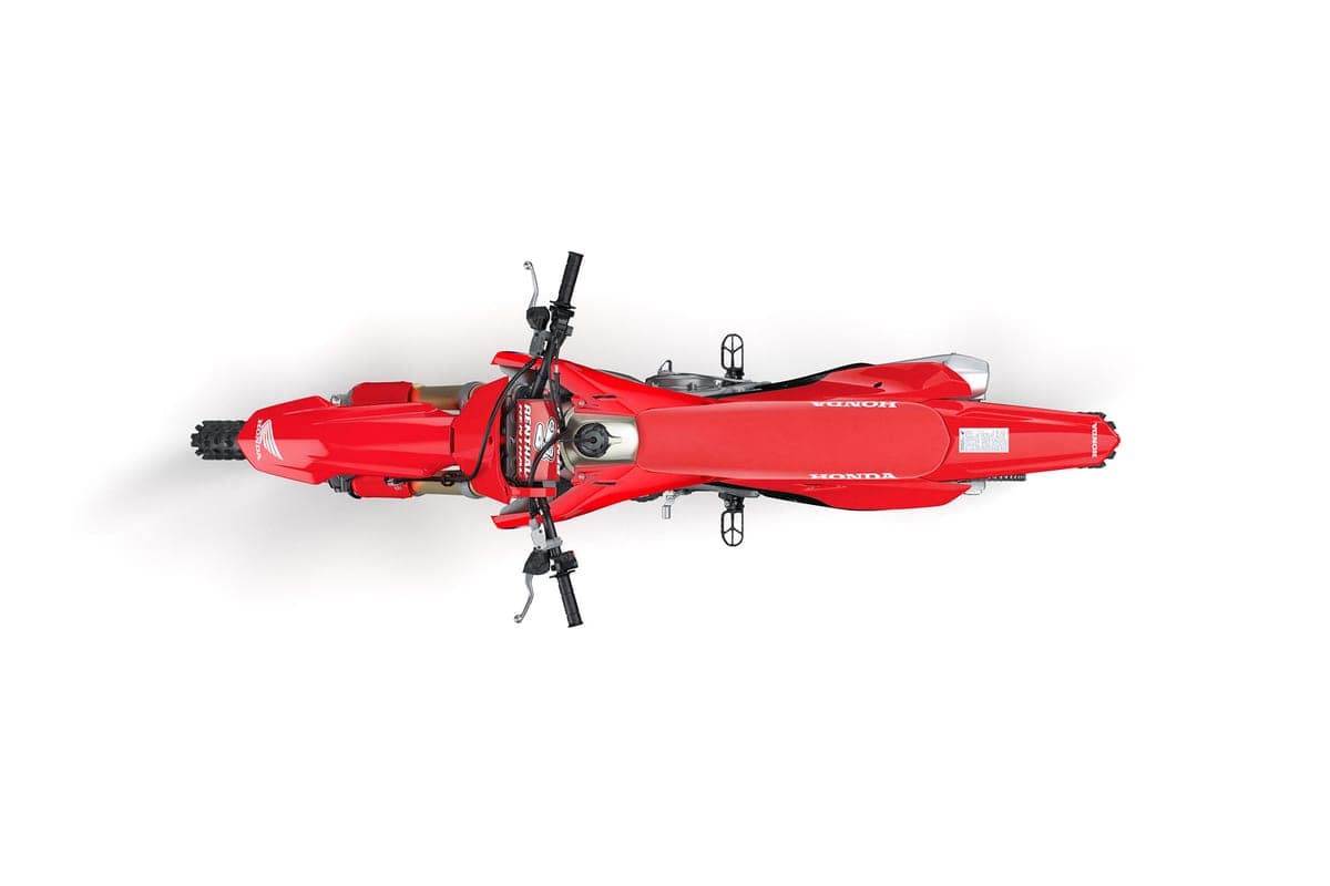 Overhead top-down studio shot of the red CRF450R showing the seat, fuel tank, handlebar layout and symmetrical bodywork