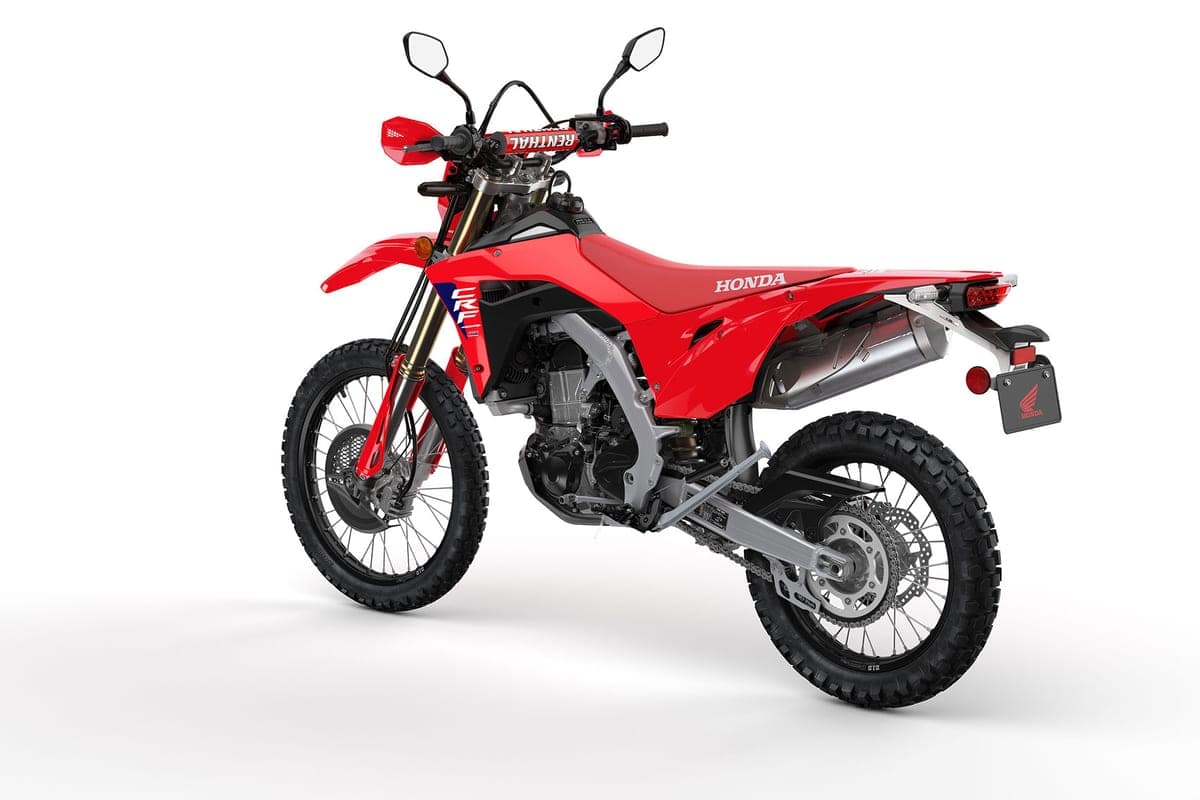 CRF450RL front three-quarter studio shot highlighting the red bodywork, CRF graphics, chain-driven rear disc and knobby dirt tires