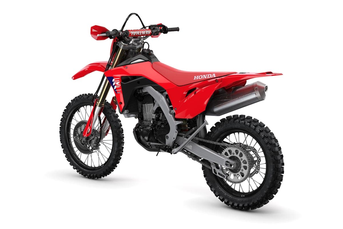 2027 Honda CRF450X rear three-quarter studio view highlighting the Renthal handlebar, silver muffler and aluminum swingarm