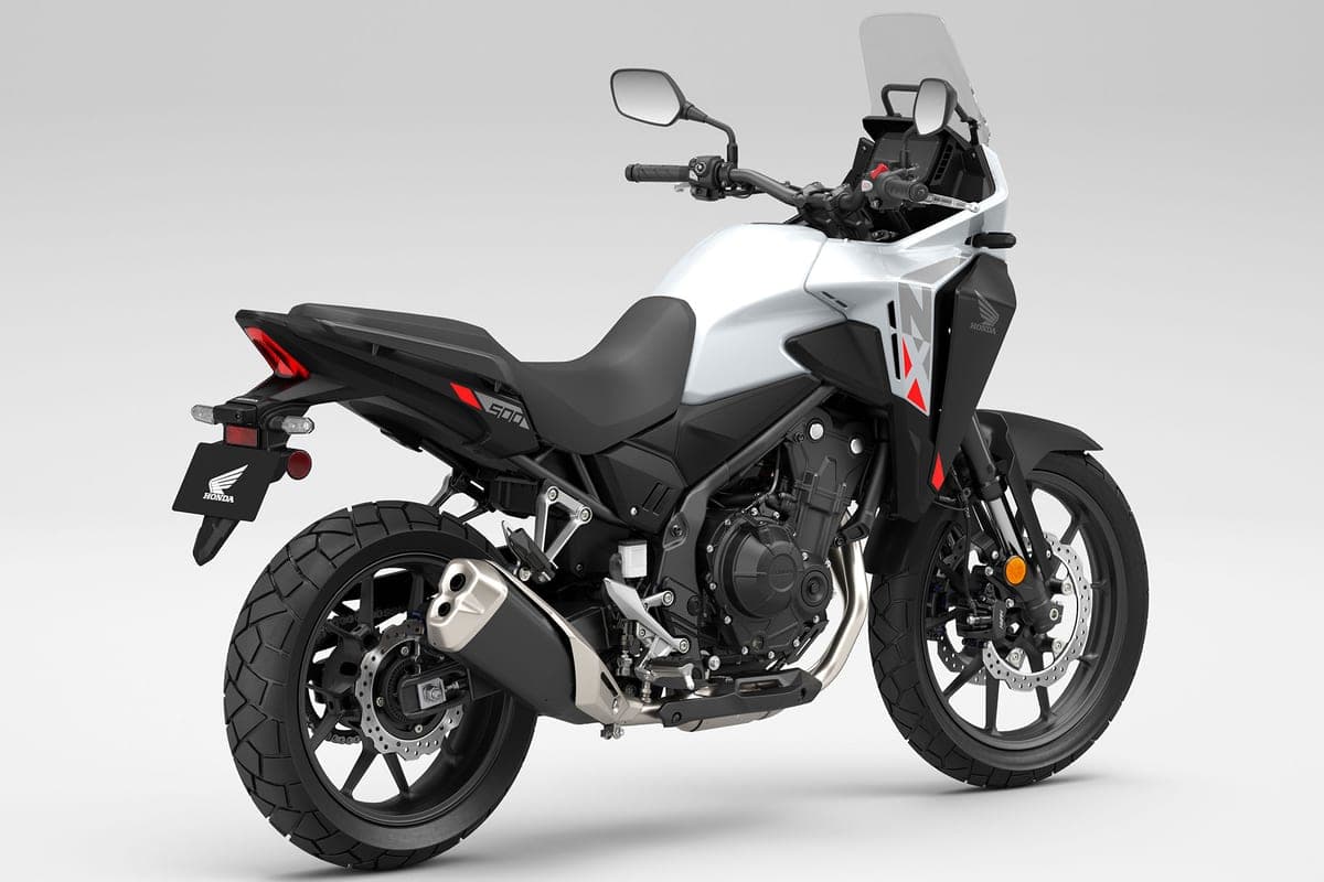 Honda NX500 rear three-quarter studio view showing the LED taillight, angular tail section, twin front discs and orange-capped fork tubes