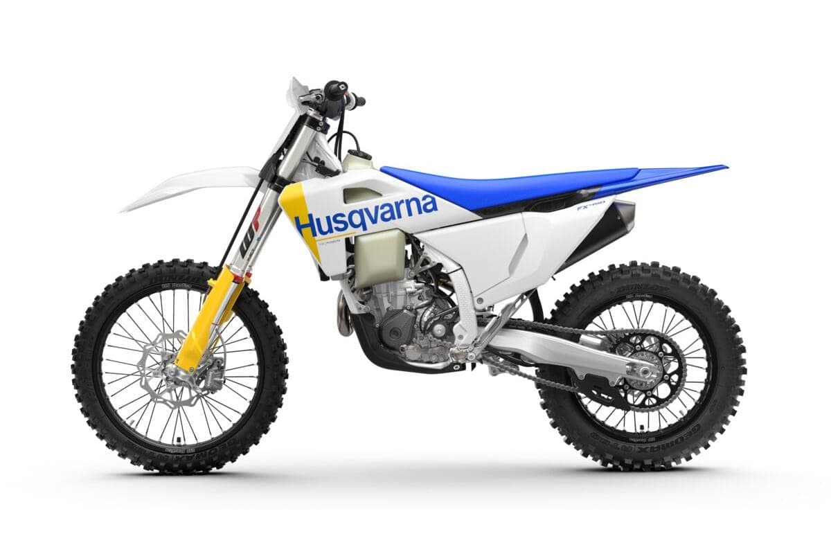 Husqvarna FX 450, left-side studio profile highlighting the blue rear fender, white radiator shrouds and stainless exhaust pipe