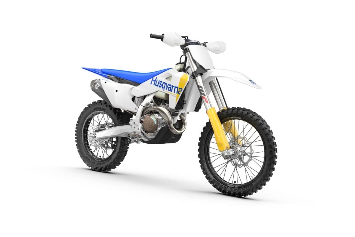 Husqvarna FX 450 front three-quarter studio view showing the white front fender, yellow WP fork and spoked front wheel