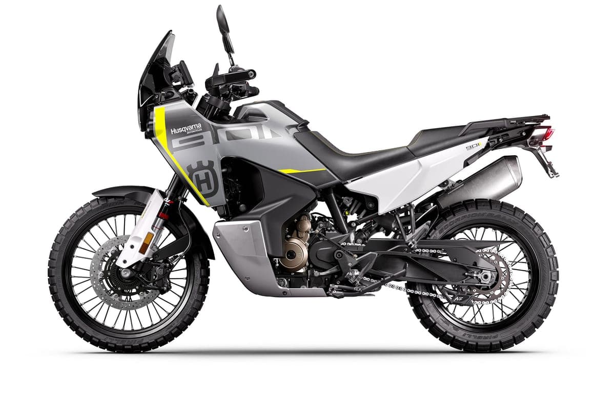Husqvarna Norden 901 left-side studio profile highlighting the underslung exhaust, upswept tail rack and Pirelli knobby tires