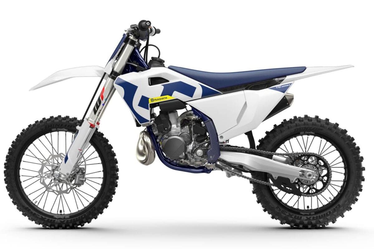 Husqvarna TC 250 front three-quarter studio view highlighting the white bodywork, navy shrouds and Dunlop knobby tires
