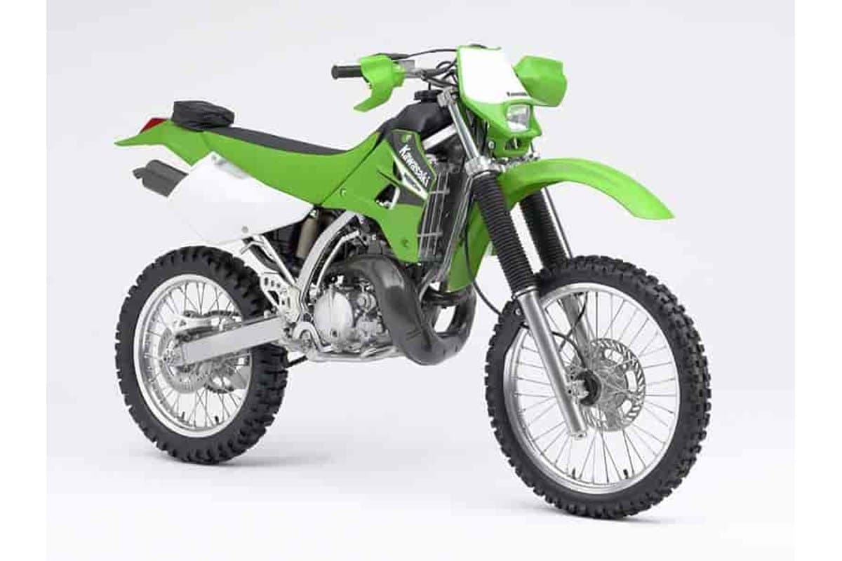 2006 Kawasaki KDX200 in green, front three-quarter studio view highlighting the round headlight, front fork guards and white radiator shrouds