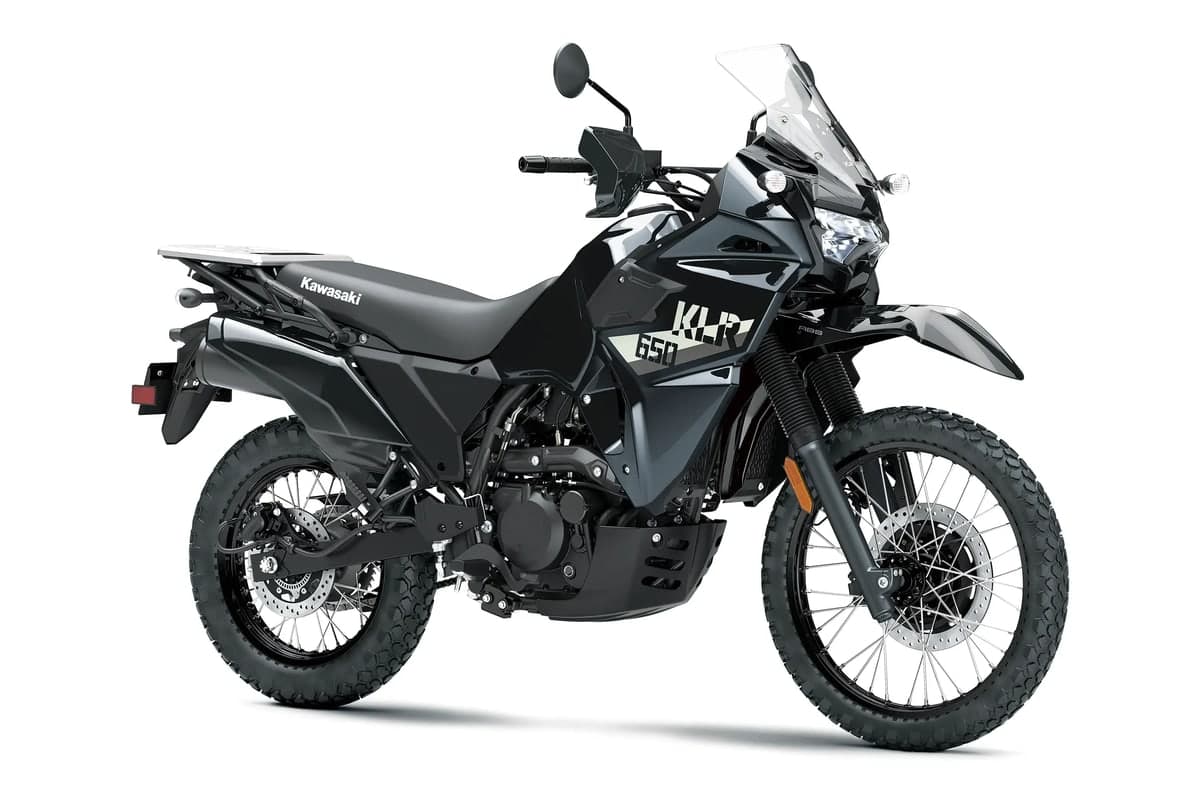 Kawasaki KLR650 front three-quarter studio view showing the tall windscreen, hand guards and headlight