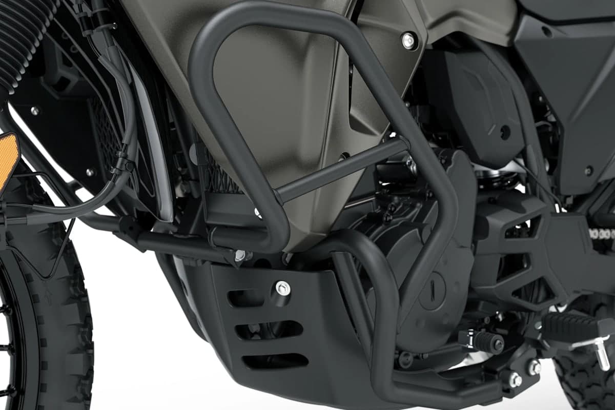 Close-up of the KLR650 DF's black tubular frame sliders and engine skid plate