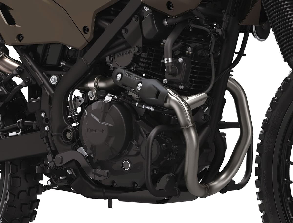 Close-up of the KLX230 DF ABS single-cylinder engine and Keihin fuel injection, showing the stainless header pipe and hand-guard mounted mirrors