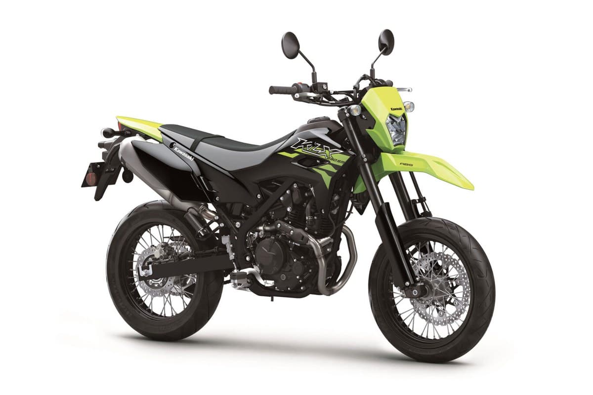 Kawasaki KLX230SM ABS in lime green and black, front three-quarter studio view showing the round headlight, tall front fender and handlebar-mounted mirrors