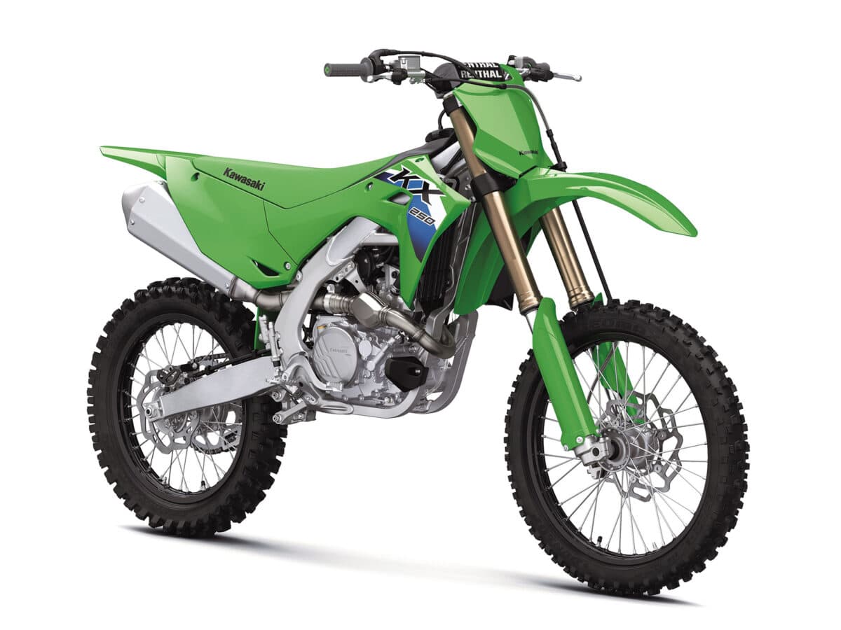 KX250F front three-quarter studio view showing the gold fork tubes, Renthal handlebar clamp, radiator shrouds and twin exhaust headers
