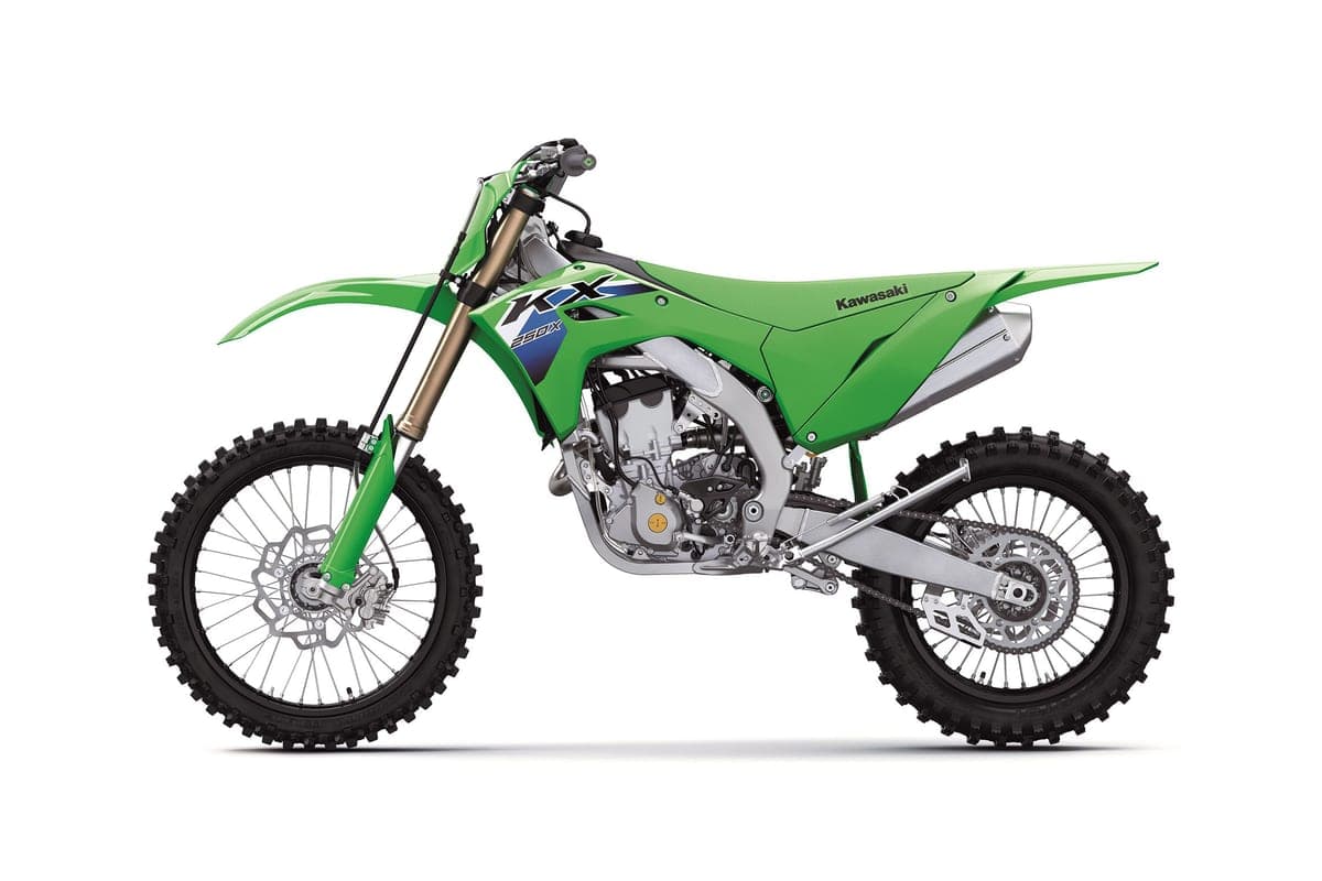 Kawasaki KX250X in green, left-side studio profile highlighting the twin-spar aluminum frame, chain guide and knobby dirt tires