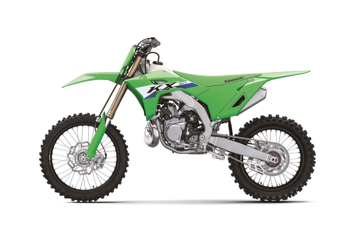 Kawasaki KX327 left-side studio profile on white, highlighting the white fuel tank, KX327 shroud graphics and spoked wheels