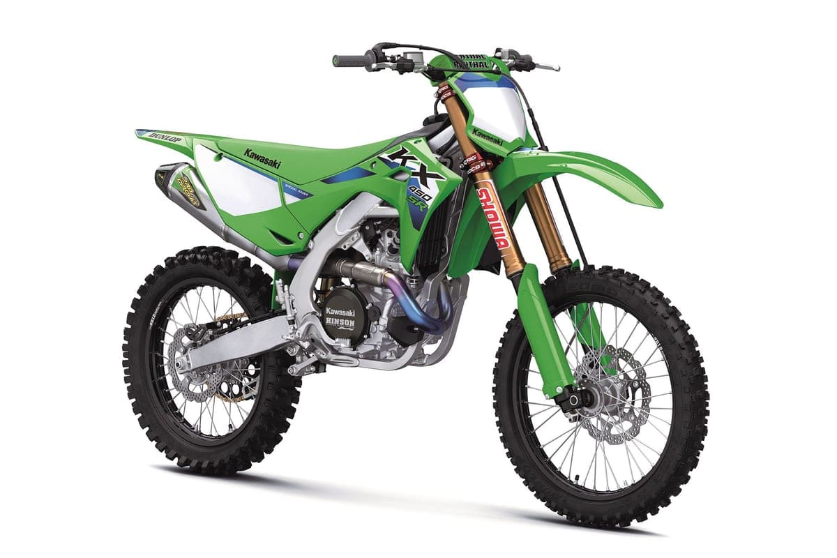 KX450SR front three-quarter studio shot on white, showing Renthal handlebars, gold Showa fork and Dunlop-badged front fender