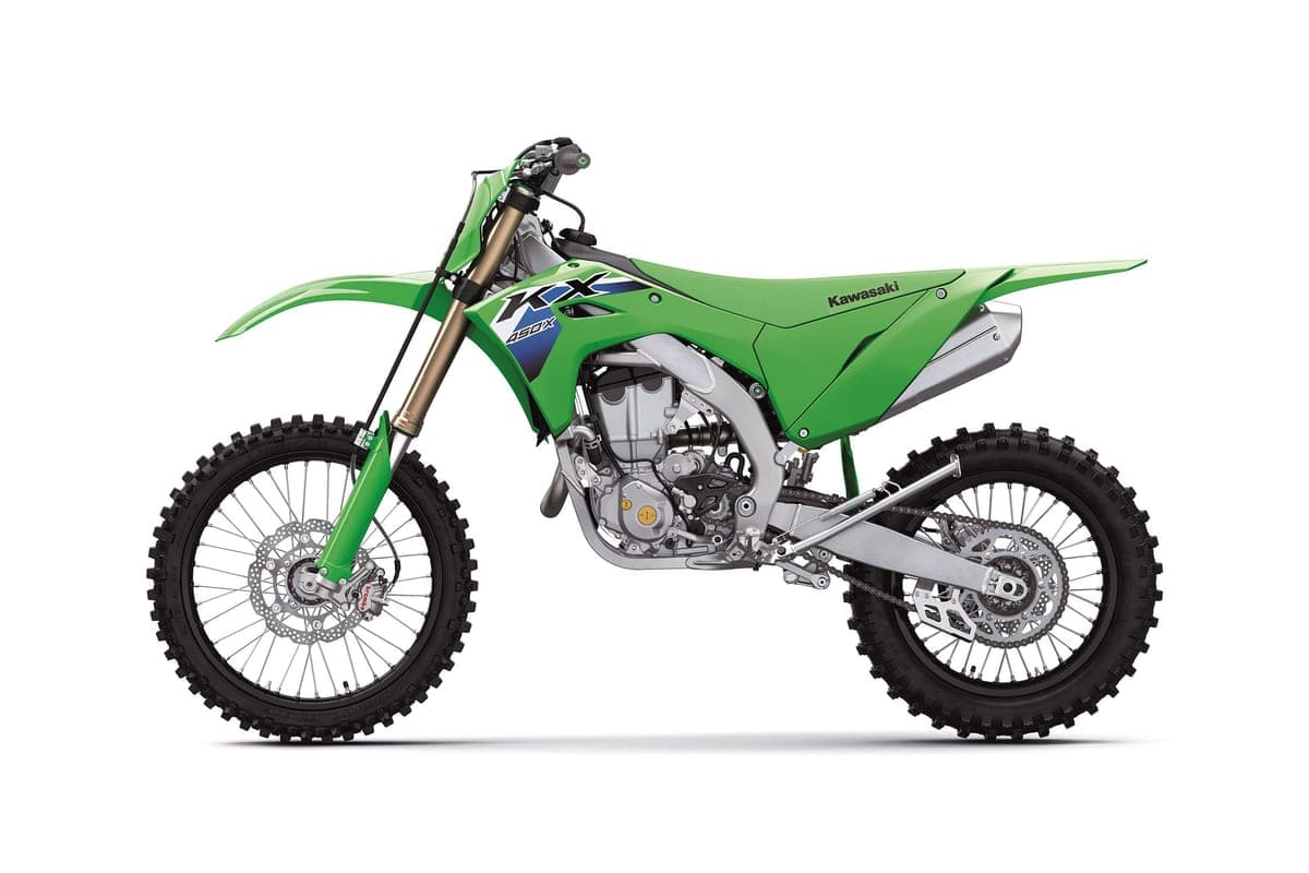 Kawasaki KX450X left-side studio profile highlighting the gold-coated fork legs, silver muffler and spoked wheels on a white background