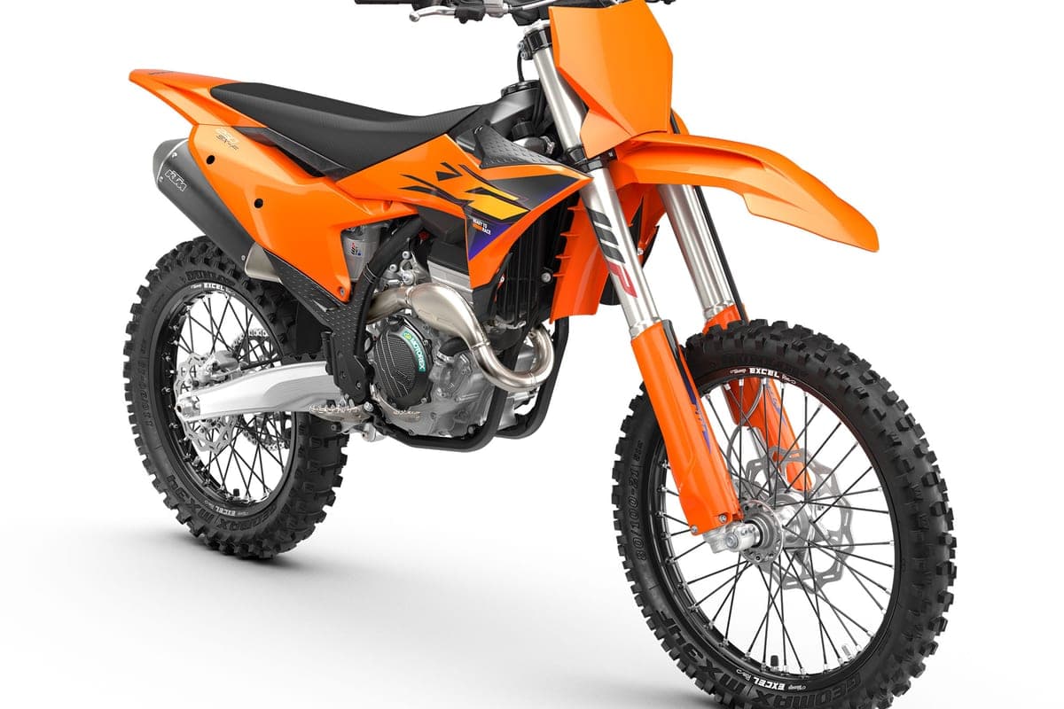 2027 KTM 250 SX-F in orange, front three-quarter studio view highlighting the radiator shrouds, exhaust header and spoked front wheel