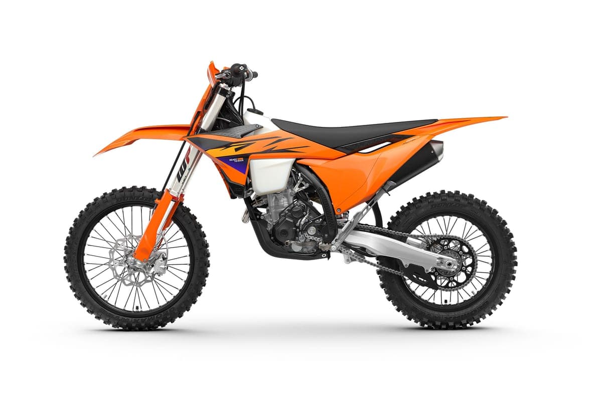 KTM 250 XC-F left-side studio profile emphasizing the chromed muffler, black frame guards and shrouded radiator area