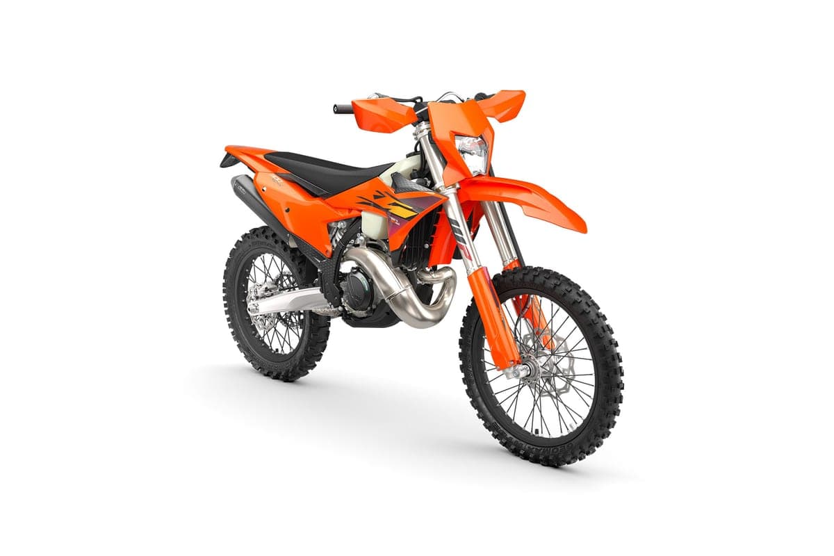 2027 KTM 300 XC-W, front three-quarter studio view highlighting the number plate headlight, radiator shrouds and spoked front wheel