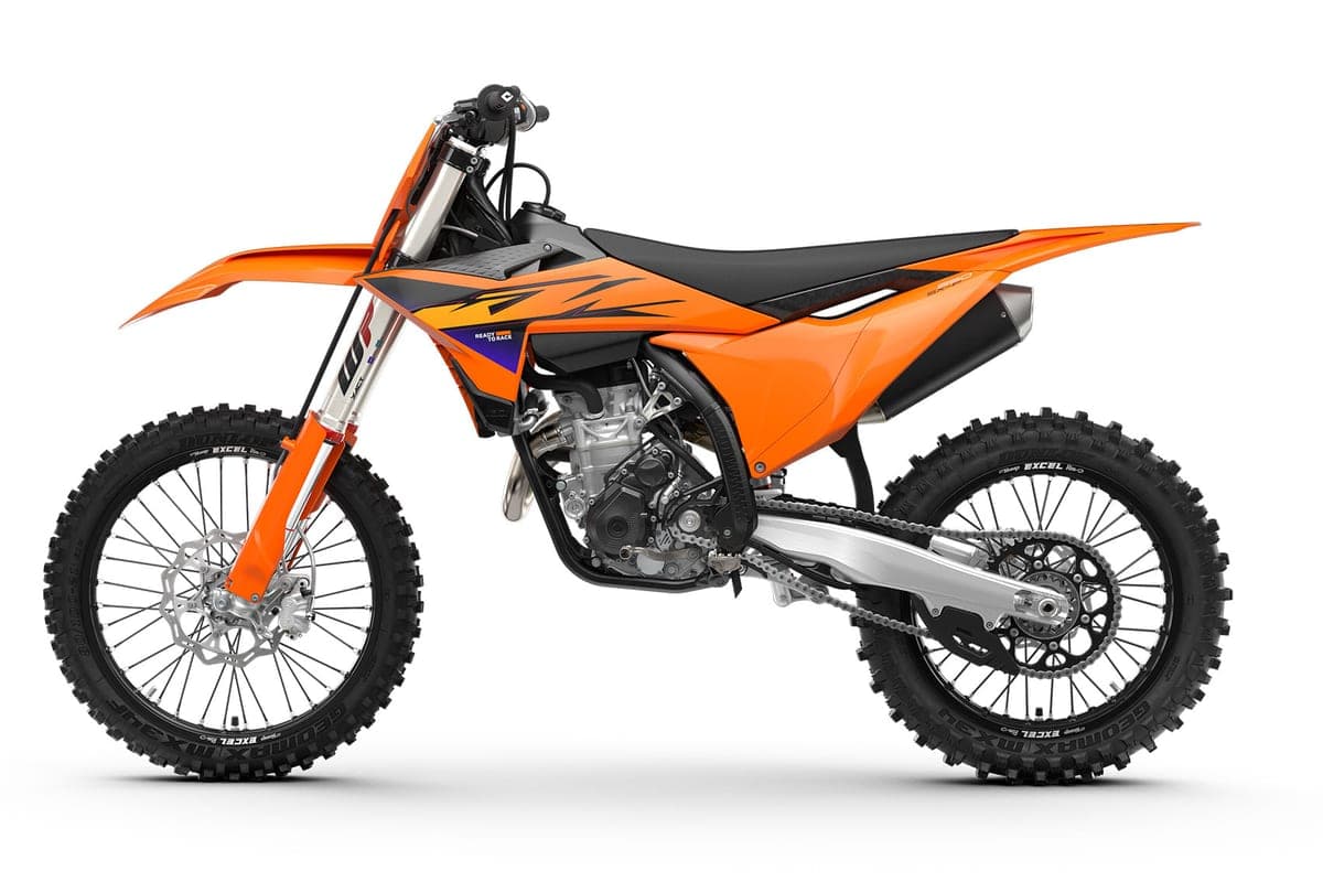 KTM 350 SX-F left-side studio profile in orange bodywork with black seat, showing the twin-spar frame, radiator shrouds and chain guide