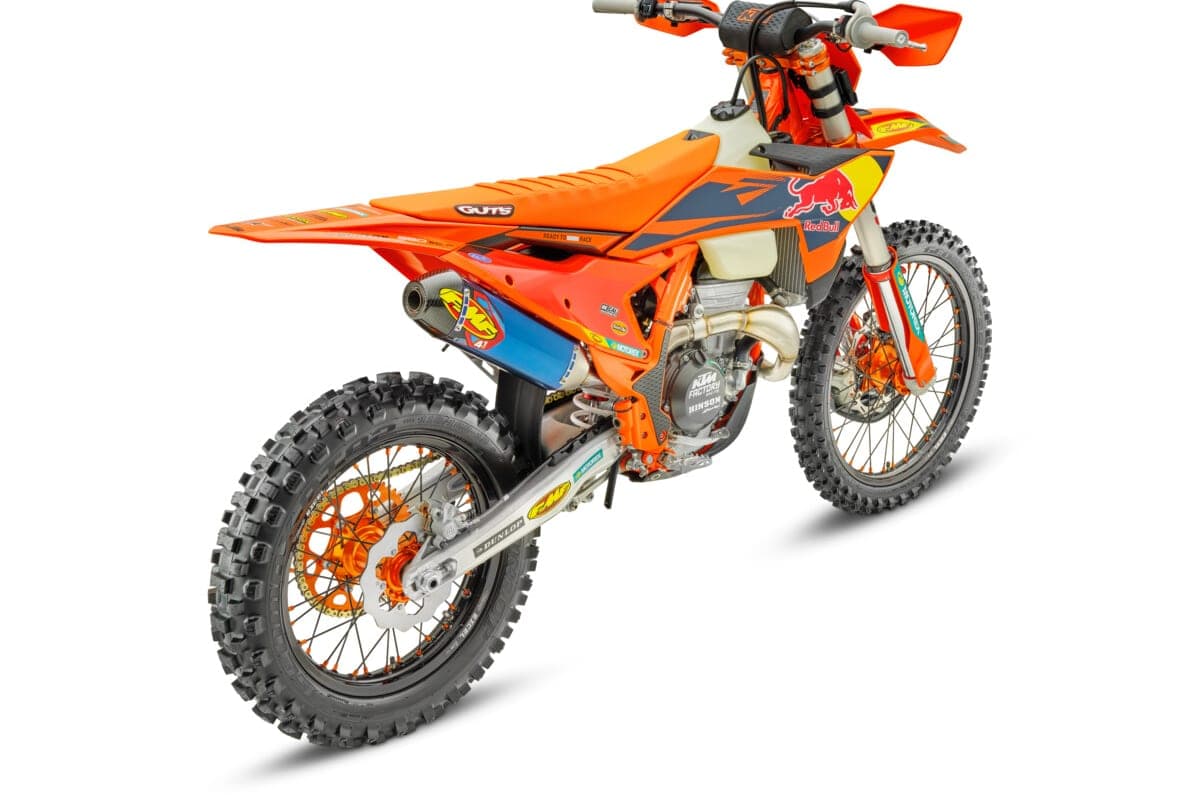 KTM 350 XC-F Factory Edition, rear three-quarter studio view showing the FMF muffler, orange frame and factory graphics kit