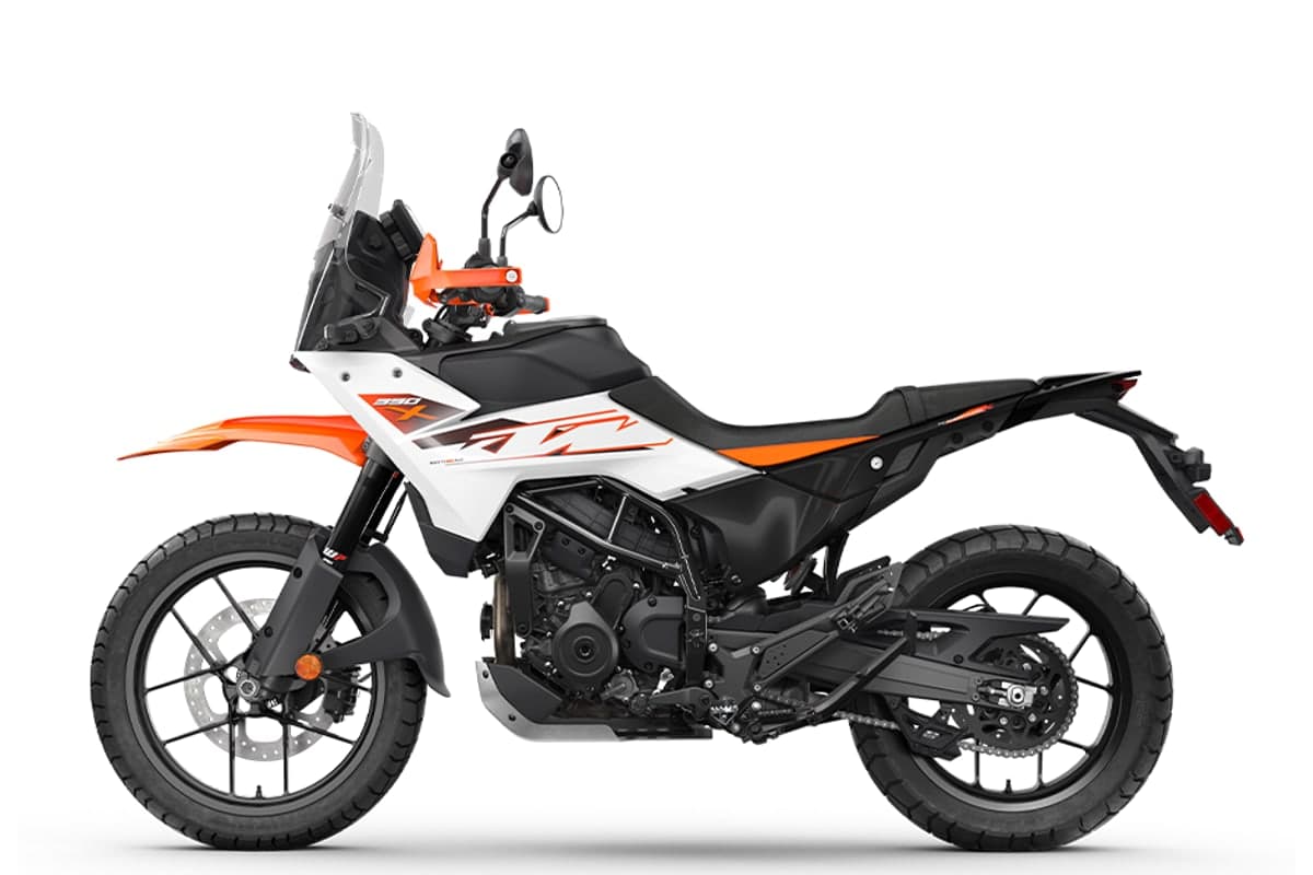 KTM 390 Adventure X in white, left-side studio profile showing the chain, rear shock and silencer