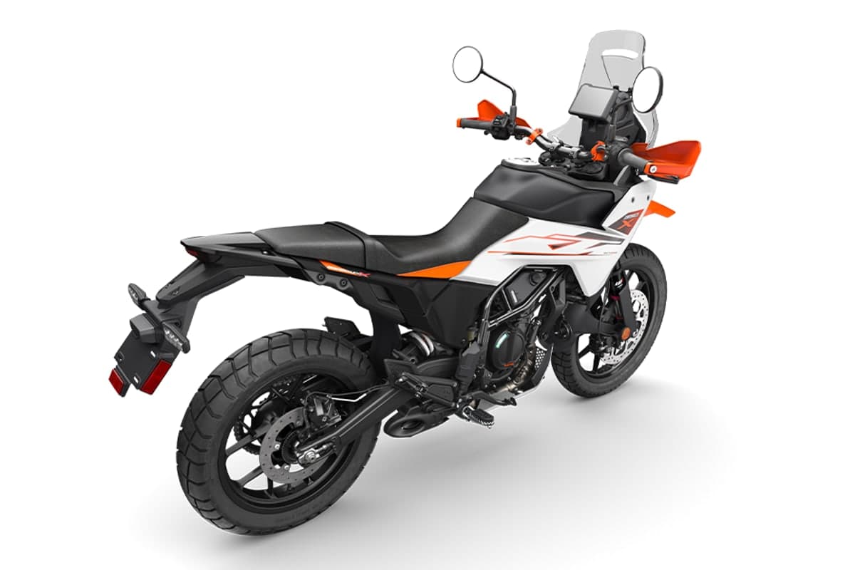 KTM 390 Adventure X in white, right-rear studio view showing the tail section, rear disc and exhaust